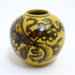 A small Chinese vase of globular form with hand painted decoration depicting stylised dragons.