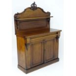 A late 19thC mahogany chiffonier with a carved up stand and single shelf above a rectangular top and