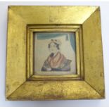 A 19thC hand painted naive watercolour portrait miniature depicting a seated woman wearing a