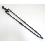 A Victorian pair of cast iron fire tongs, 27" long Please Note - we do not make reference to the