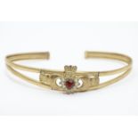 A 9ct bracelet with Claddagh decoration to centre set with red and white stones. Please Note - we do