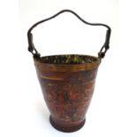 A 19thC leather fire bucket of tapered cylindrical form with a leather strap handle, stud