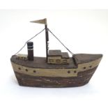 A 20thC naive folk art wooden model of a steamship / boat with polychrome decoration. Approx. 6 1/4"