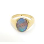 A 14ct gold ring set with opal in an Art Deco setting with gold line detail. Ring size approx L