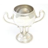 A silver plate Art Nouveau twin handled trophy cup 9" high Please Note - we do not make reference to