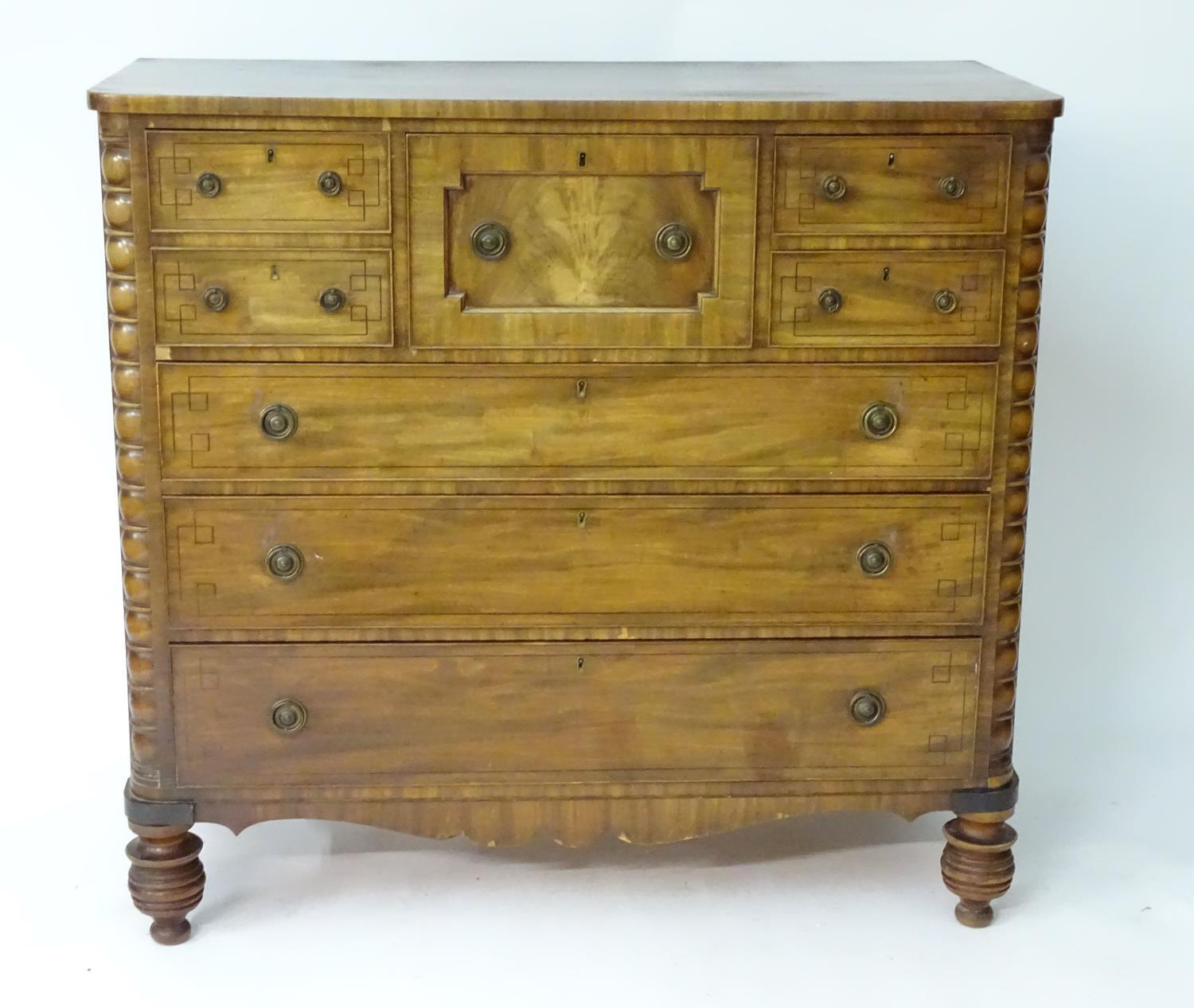 A late 19thC mahogany north country chest of drawers comprising a central geometrically moulded