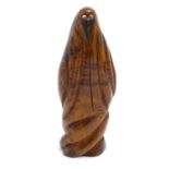 A 20thC carved wooden sculpture depicting a Middle Eastern veiled woman with inlaid mother of