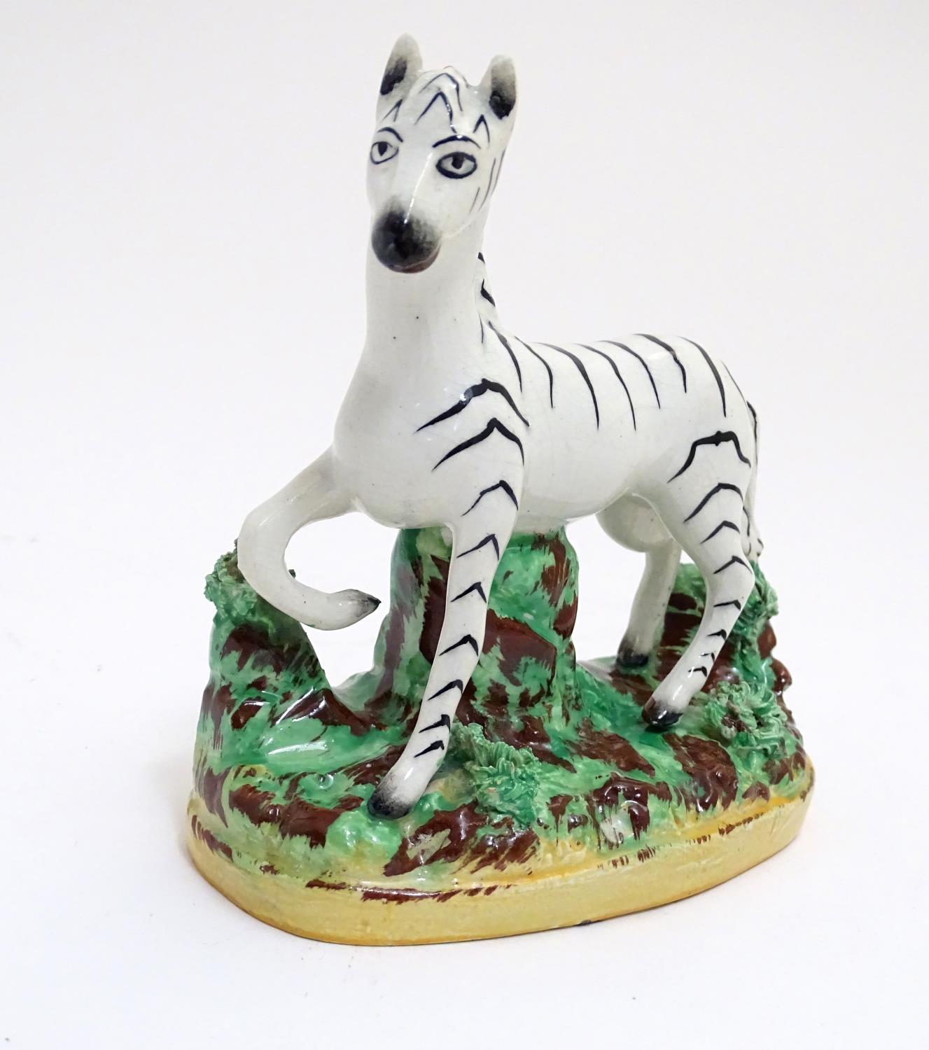 A Staffordshire figure modelled as a zebra on a naturalistic oval base. Approx. 4 3/4" high Please - Image 3 of 6