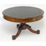 A mid 19thC mahogany drum library table with a circular moulded top containing an inset leather