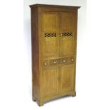 An early 19thC oak Welsh bread and cheese cupboard with a moulded cornice above quarter sawn oak