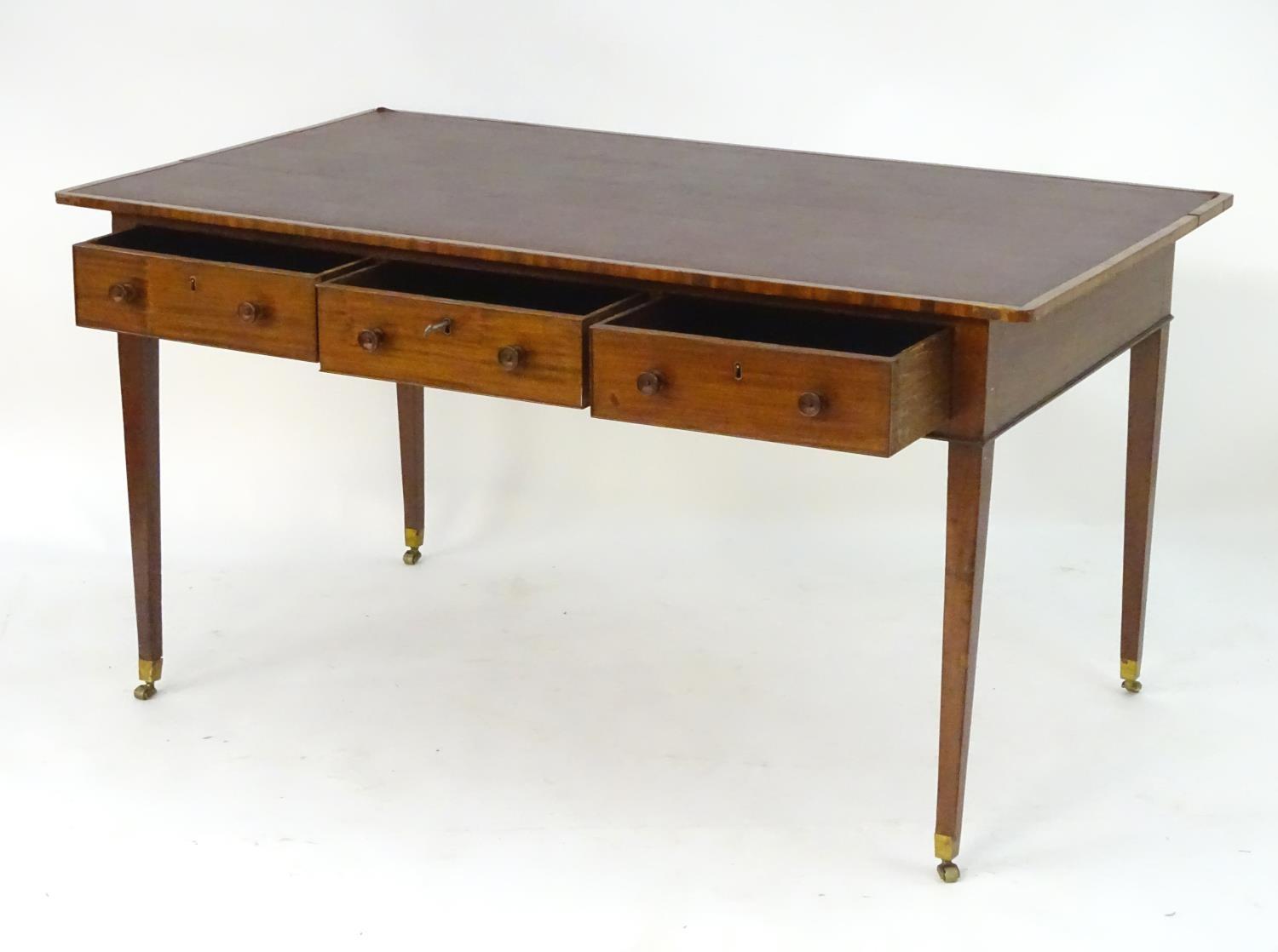 A late 18thC / early 19thC mahogany writing table with an inset top above three short drawers and - Image 5 of 7