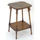 An early 20thC walnut occasional table with an octagonal top above four turned splayed legs with