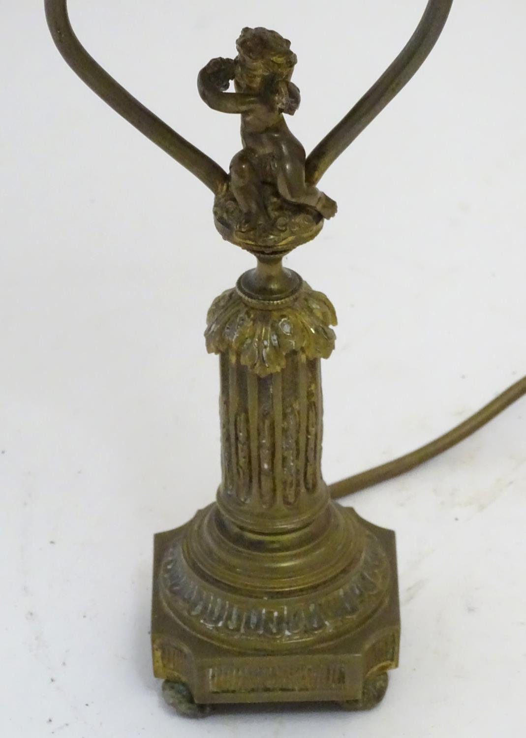 A mid to late 20thC brass table lamp, formed as a Corinthian column surmounted by a putto. 22" - Image 5 of 6