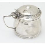 A silver mustard pot with blue glass liner, hallmarked Birmingham 1935 maker J B Chatterley & Sons