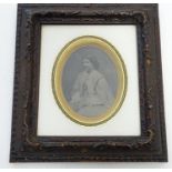 A Victorian daguerreotype photographic portrait of a seated woman, framed. Ascribed verso: An