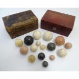 A quantity of polished agate spheres / balls of various sizes and colours, contained within two late