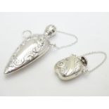 Two white metal scent bottles. The largest 2 1/2" long Please Note - we do not make reference to the