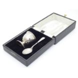 A silver egg cup and spoon hallmarked Birmingham 1974/75 maker B & Co. Cased. Please Note - we do