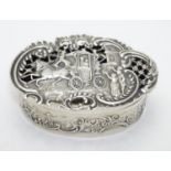 A silver pot pourri box with coaching scene to the pierced and embossed lid. Hallmarked London