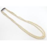 A double strand pearl necklace / choker of graduated pearls with silver and marcasite clasp.