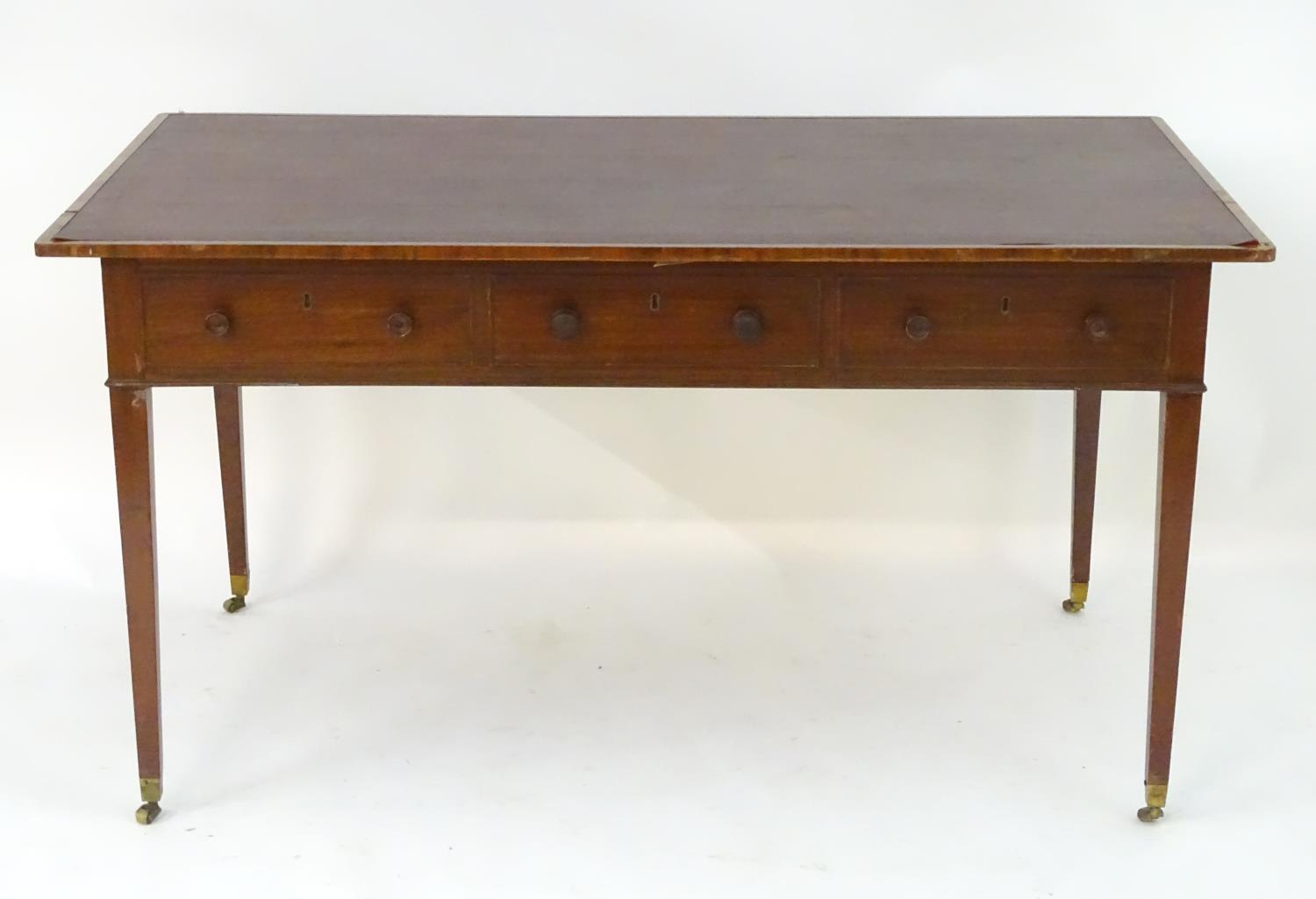A late 18thC / early 19thC mahogany writing table with an inset top above three short drawers and - Image 2 of 7