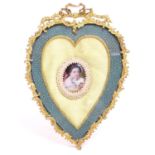 A 19thC gilt brass easel back frame of heart form with ribbon cresting and a shagreen surround, with