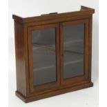 An early 20thC mahogany glazed bookcase containing three shelves within. 32" long x 9 1/2" wide x