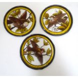 Three late 19th / early 20thC stained and painted glass circular panels depicting sparrow birds