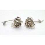 A pair of sterling silver roses marked 'Spain' and bearing importers marks for Israel Freeman & Son.