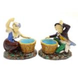 A pair of Minton style majolica figures after designs by Albert Carrier Belleuse. A washer woman and