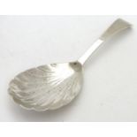 A 19thC silver shell formed caddy spoon. Hallmarked London 1820 maker Thomas Wilkes Barker. 4"