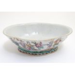 A Chinese bowl of elongated quatrefoil form decorated with sage figures and attendants in a