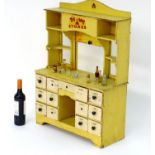 Toy: A 20thC Tri-ang Stores dresser style child's wooden play shop the bottom section with 13 fitted