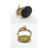 A Victorian gilt metal pedant fob seal with butterfly decoration and with engraved intaglio seal