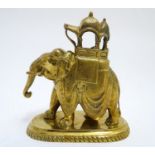 A 20thC brass elephant carrying a decorated howdah. Approx. 6" high Please Note - we do not make