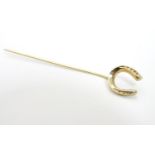 A 9ct gold stick / stock pin surmounted by a horseshoe 2 1/4" long overall Please Note - we do not