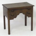 An 18thC oak lowboy with a moulded rectangular top above a single long and two short false drawers