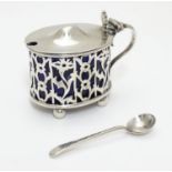 A silver mustard pot with blue glass liner. Hallmarked Birmingham 1901 maker Henry Charles Freeman