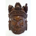 A 20thC Chinese carved hardwood mask with carved dragon detail and inset eyes. Approx. 10 1/4" high.