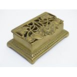 An Art Nouveau style brass stamp box with two compartments, the pierced cover with sunflower and