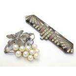 An Art deco brooch set with white stones and pink and black enamel detail 3" wide. together with a