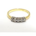 An 18ct gold ring set with 5 diamonds in a linear setting. Ring size approx. H Please Note - we do