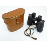 A cased pair of mid 20thC Zeiss Jenoptem 10 x 50W field glasses / binoculars, with blacked finish