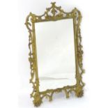 A 19thC Rococo style giltwood mirror with a pierced and carved surround. 23" wide x 37" high. Please