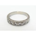 A white gold half eternity ring set with 7 graduated diamonds. Ring size approx K Please Note - we