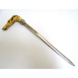 A Victorian silver plate paper knife / letter opener the carved handle formed as the head of a