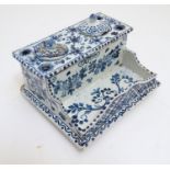 A Continental Delft style blue and white standish / inkwell with floral decoration. Marked under.