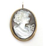 A 9ct gold pendant / brooch set with mother of pearl abalone carved cameo 1 1/2" long Please