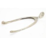 Silver sugar tongs of wishbone form with sprung action. Hallmarked Birmingham 1904, maker M.Bros (