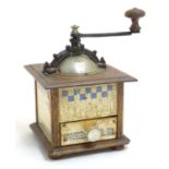 An early 20thC French coffee grinder by Peugeot Freres, 9" tall, 6" wide Please Note - we do not